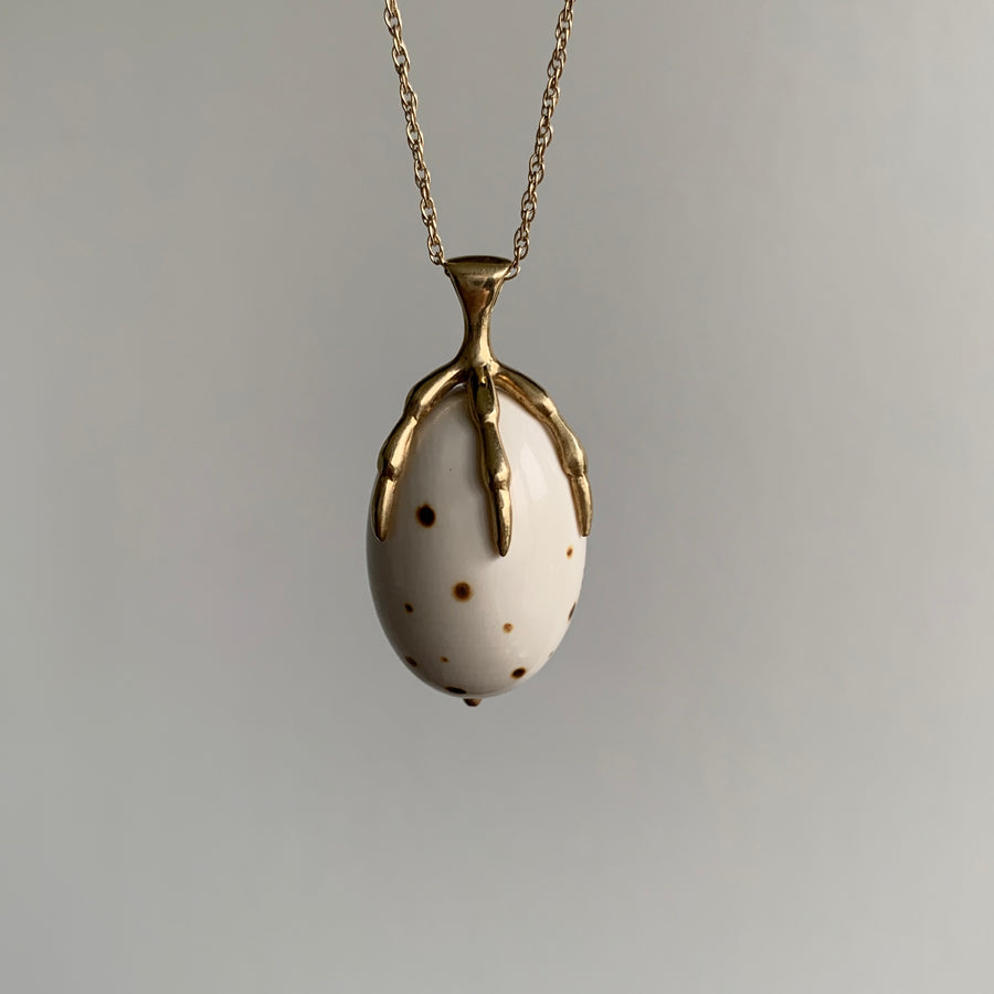 10k Gold and & Spotted Mammoth Ivory Egg Claw Necklace hanging