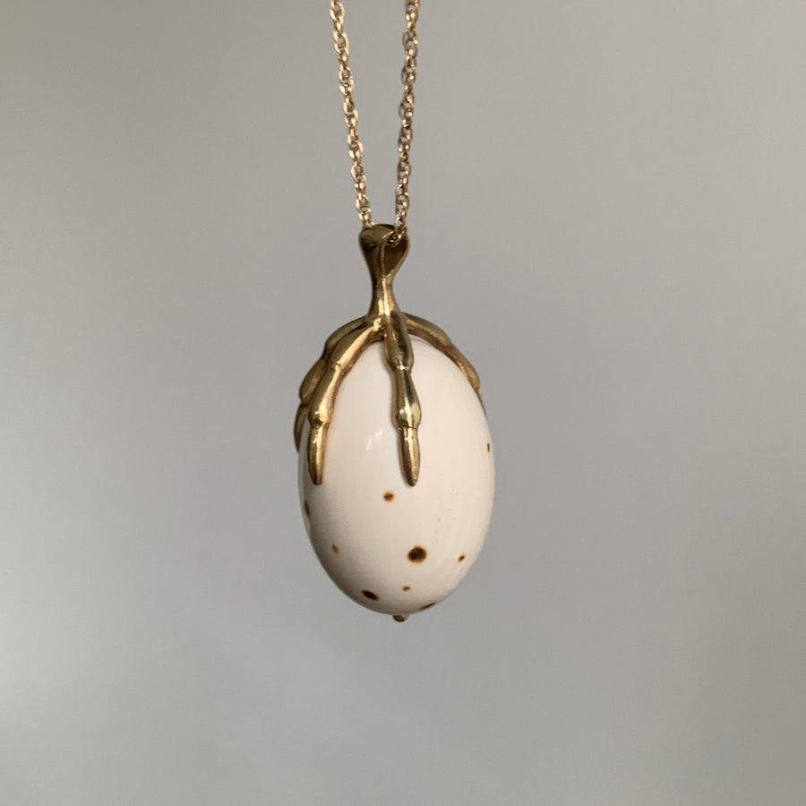 10k Gold and & Spotted Mammoth Ivory Egg Claw Necklace hanging side