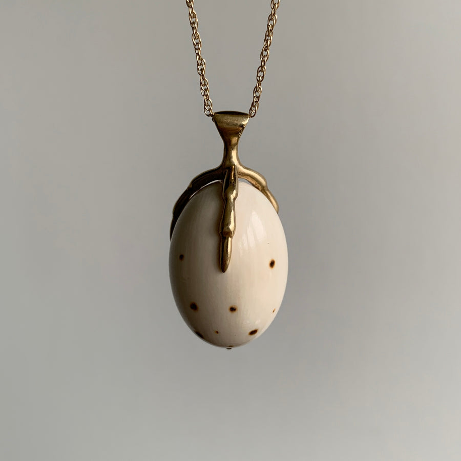 10k Gold and & Spotted Mammoth Ivory Egg Claw Necklace hanging side view
