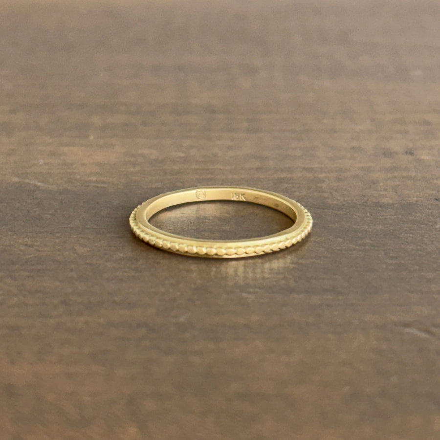 Gold ring on a textured brown surface