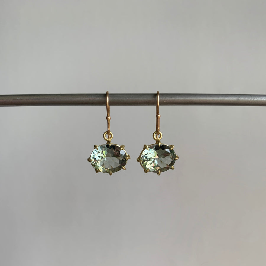 A pair of green amethyst earrings set in yellow gold hanging