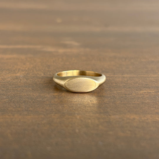 Gold ring on a wooden surface