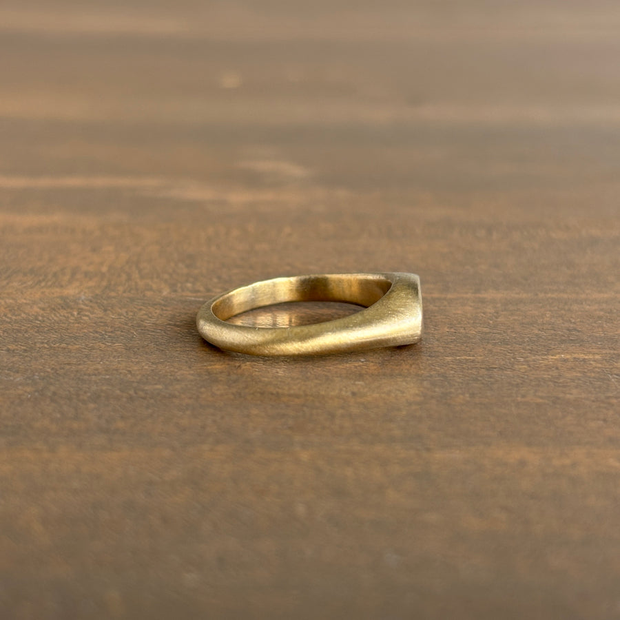 Gold ring on a wooden surface