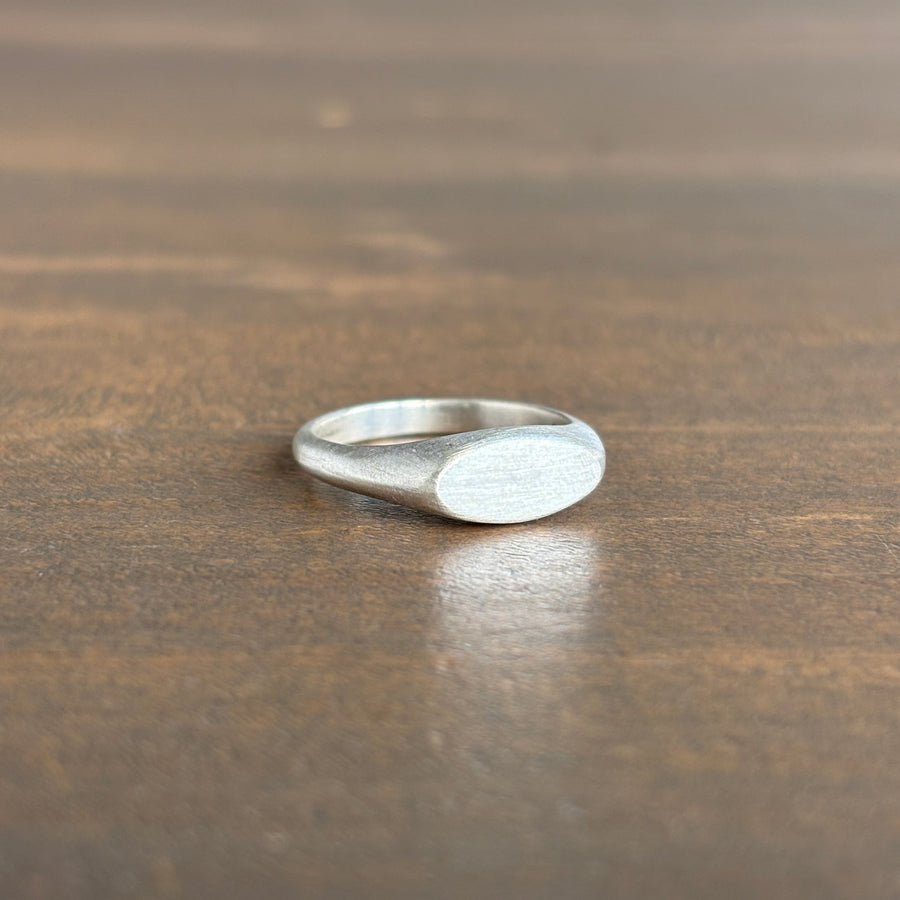 Silver ring on a wooden surface
