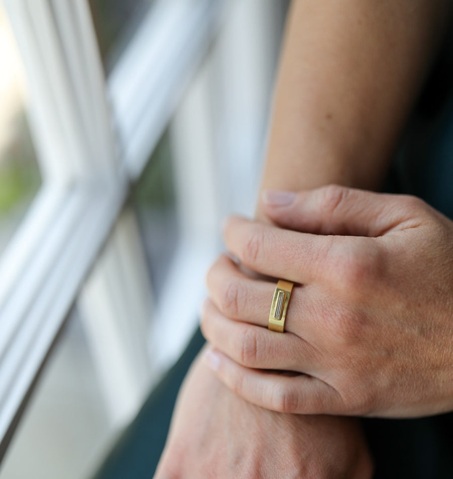 Gold diamond ring with a rectangular engraving on model