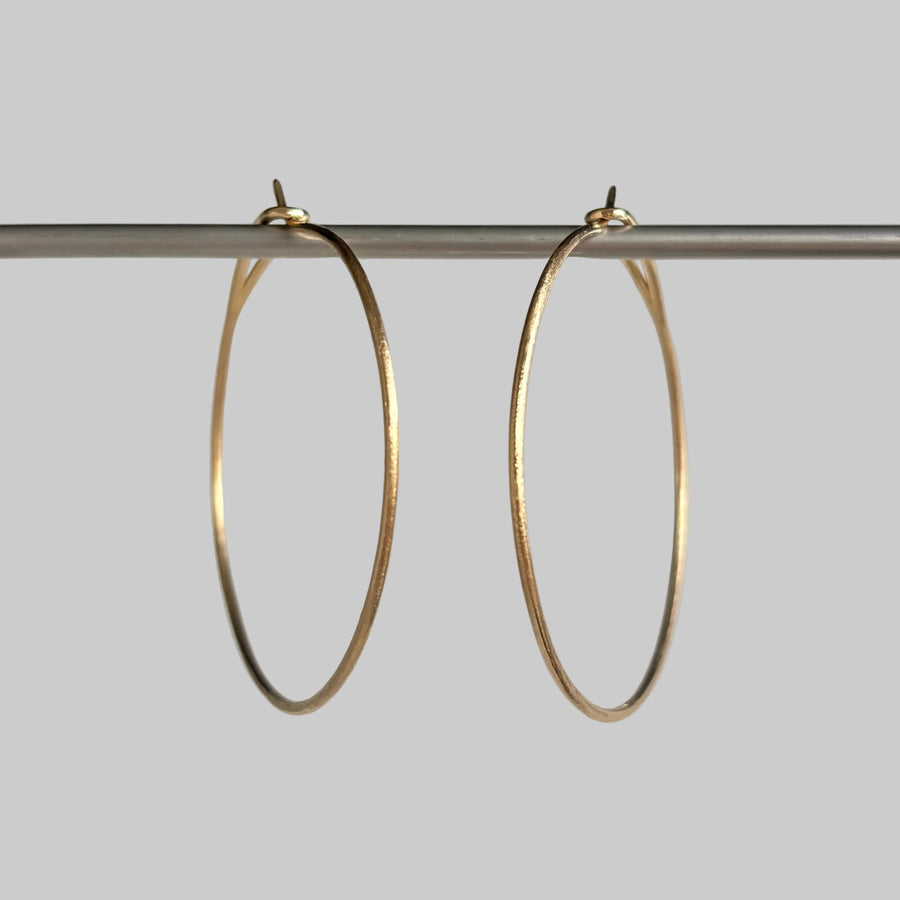 Eye of the Needle Hoop Earrings in 14k Gold hanging 