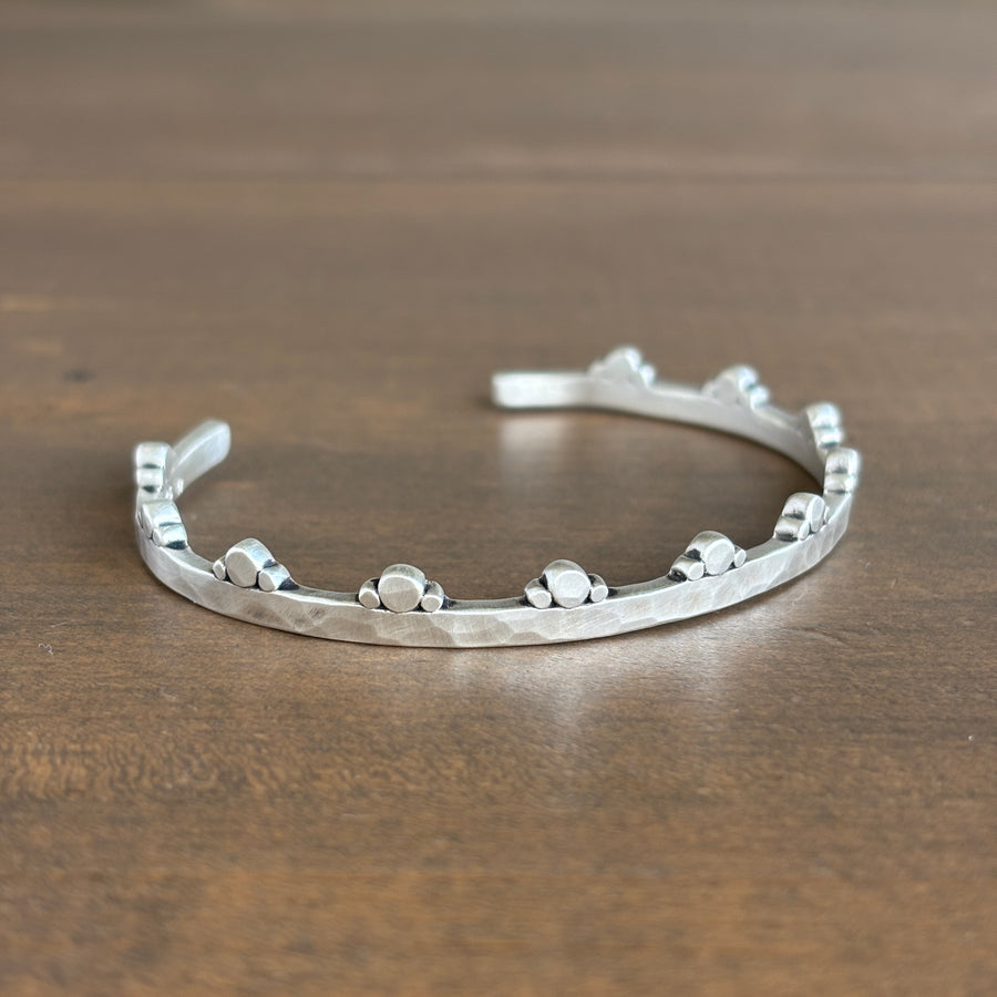Silver bracelet on a wooden surface
