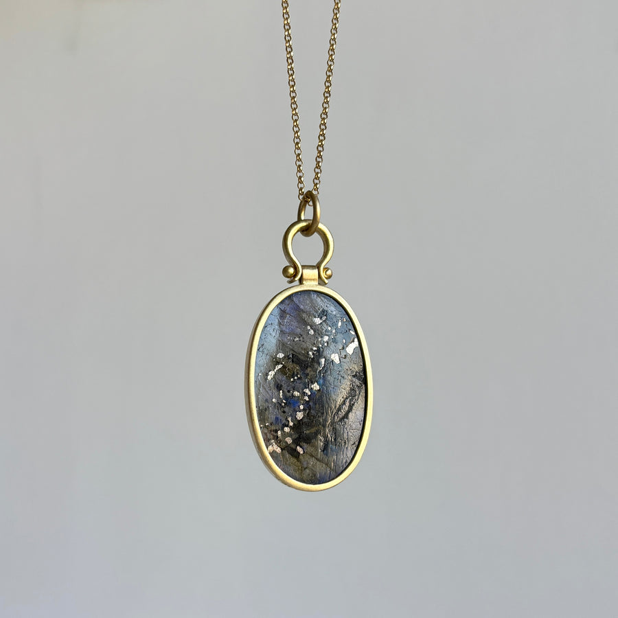 Necklace with an oval pendant on a gray background