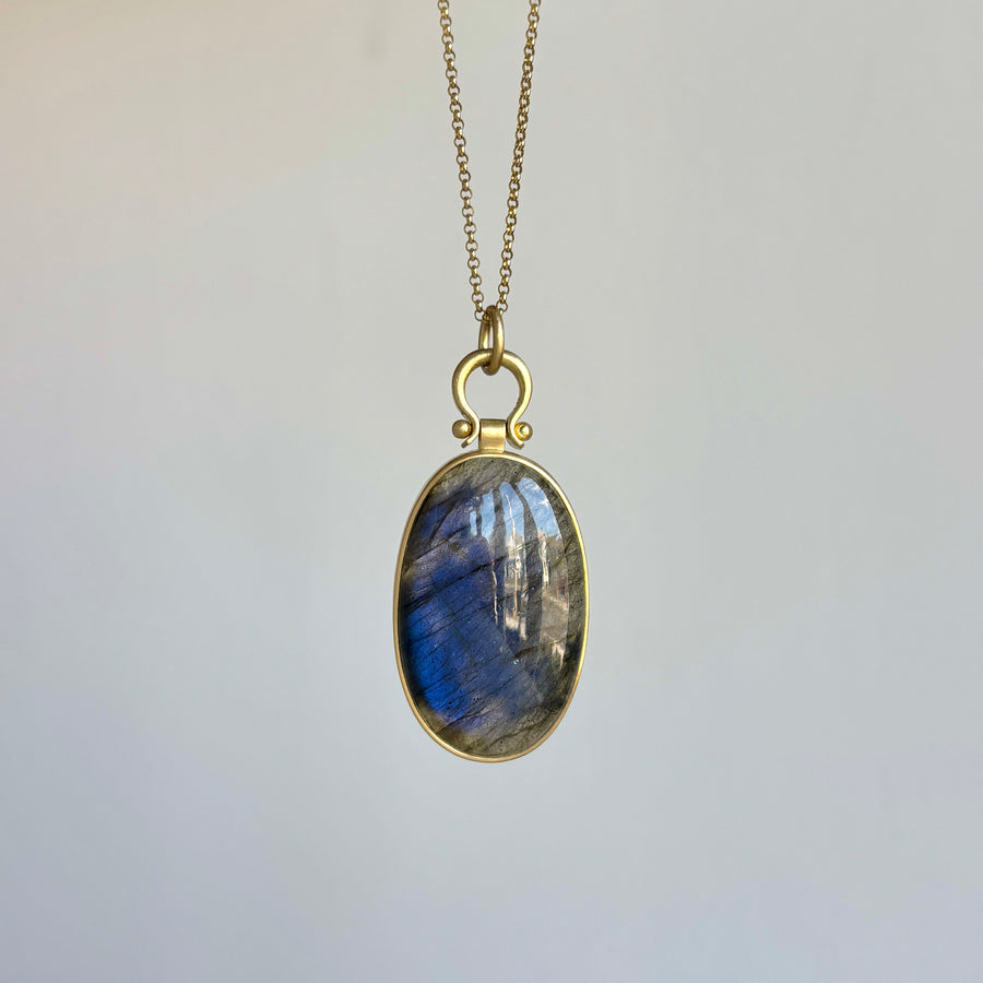 Necklace with a Labradorite pendant on a light gray background