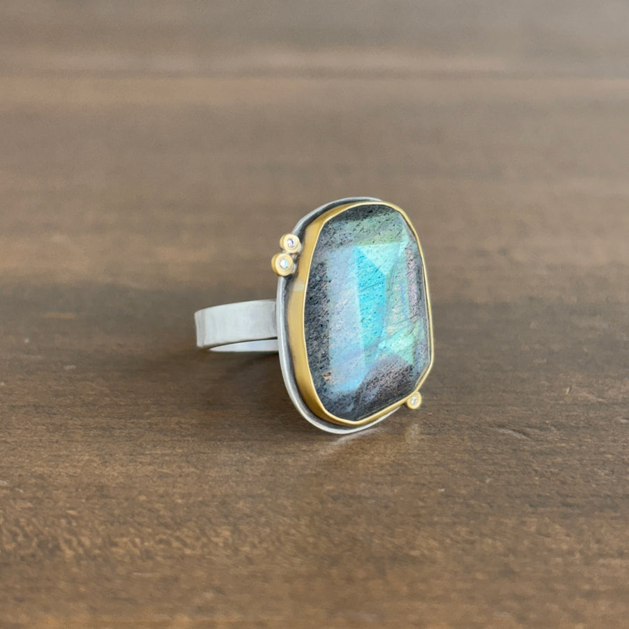 Ring with a colorful stone on a wooden surface