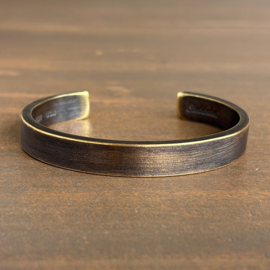 Bronze bracelet on a wooden surface
