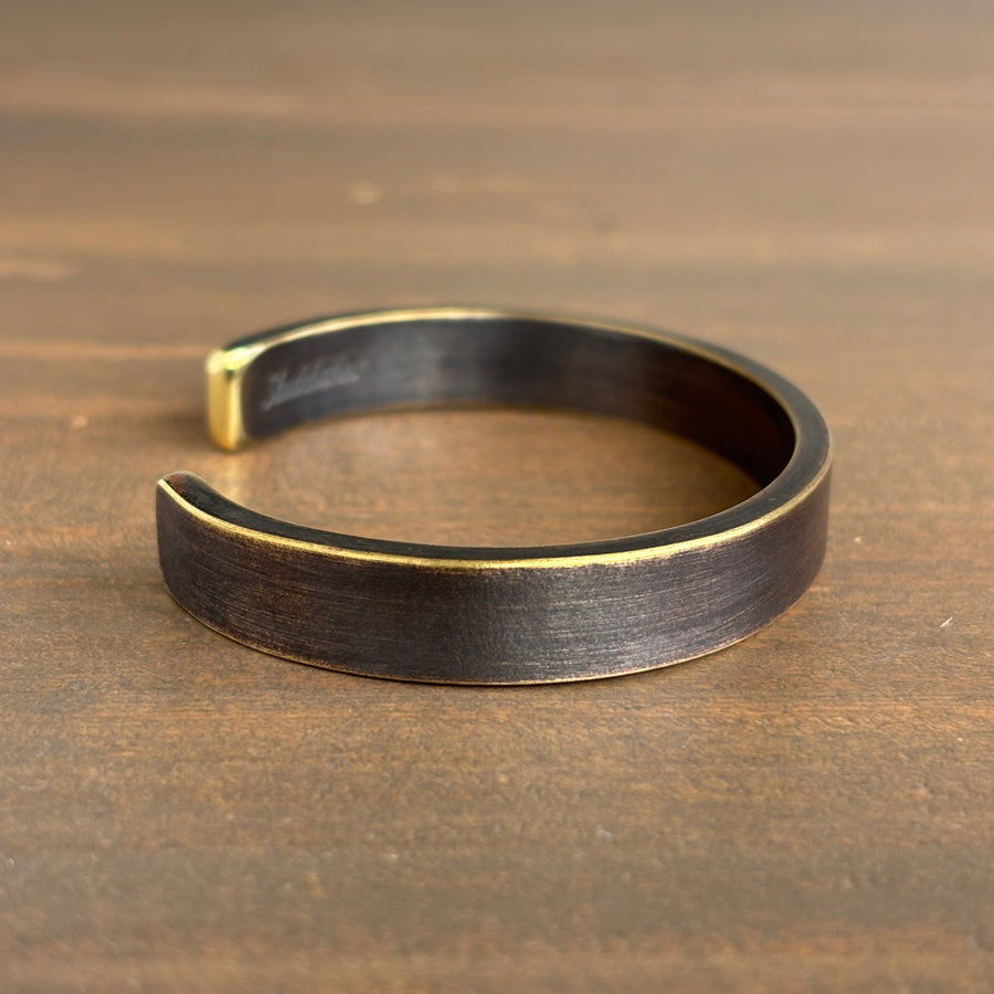 Bronze bracelet on a wooden surface