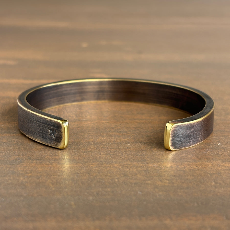 Bronze bracelet on a wooden surface