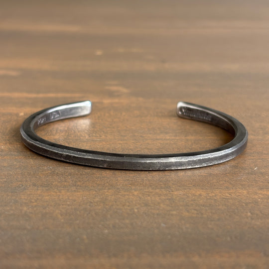 Silver bracelet on a wooden surface