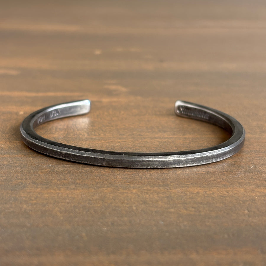 Silver bracelet on a wooden surface