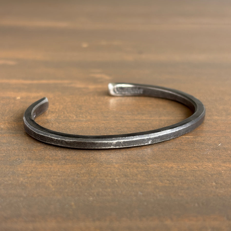 Silver bracelet on a wooden surface