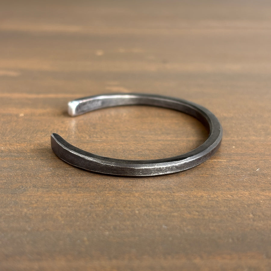 Silver bracelet on a wooden surface