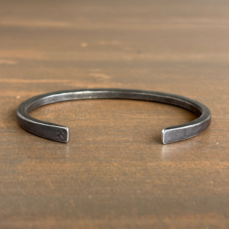 Silver bracelet on a wooden surface