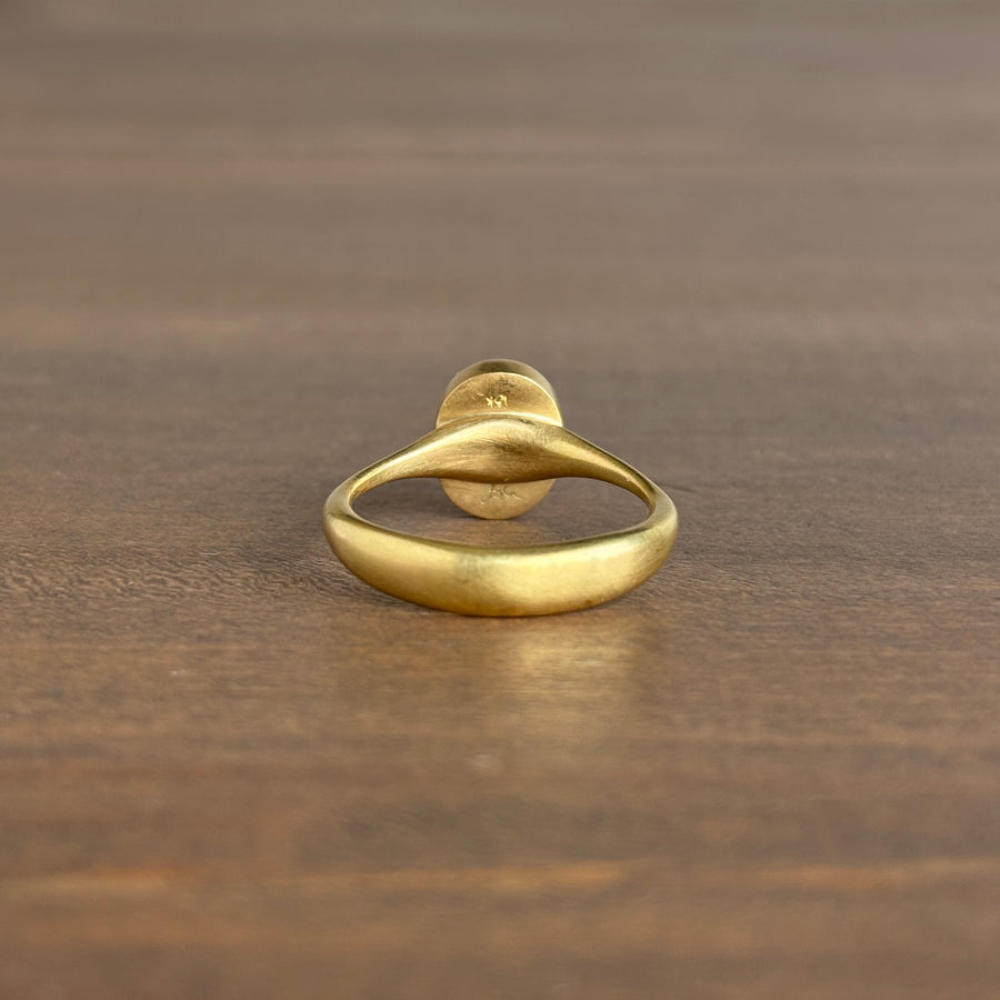 Gold ring on a wooden surface