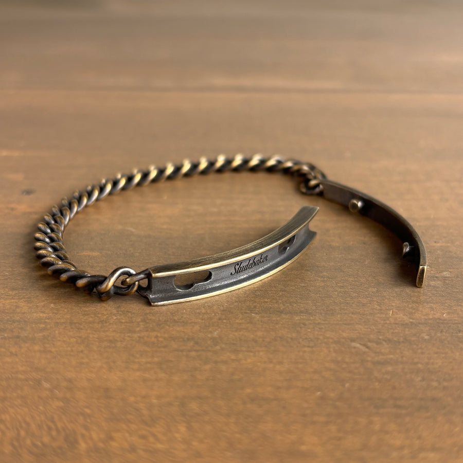 Brass bracelet with a unique design on a wooden surface