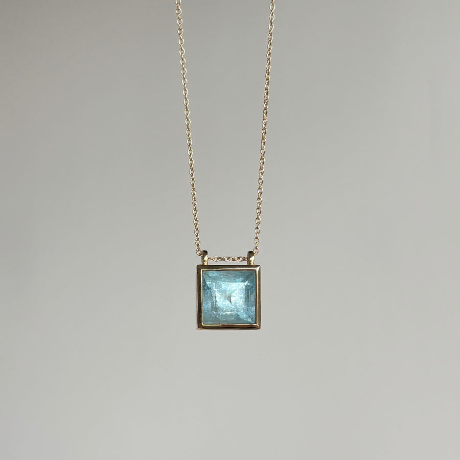 Necklace with a square pendant on a gray background