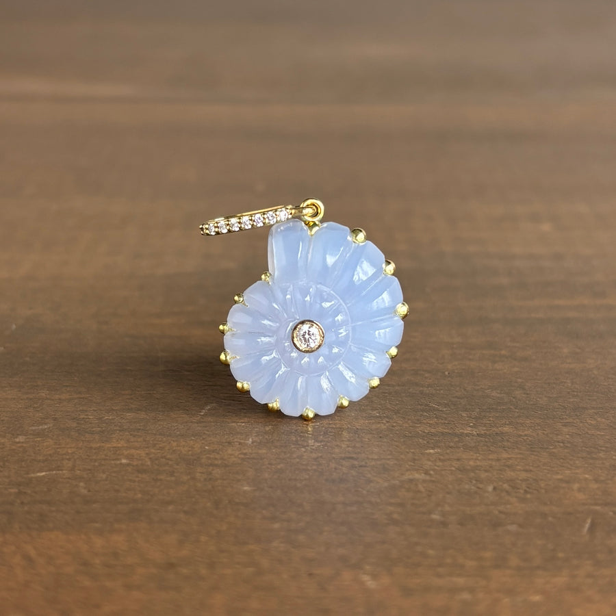 Sophie Gardner 18k gold Blue chalcedony ammonite pendant with gold accents on a wooden surface