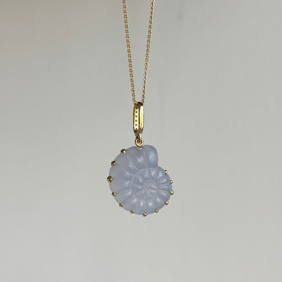 Necklace with a light blue pendant on a gray background