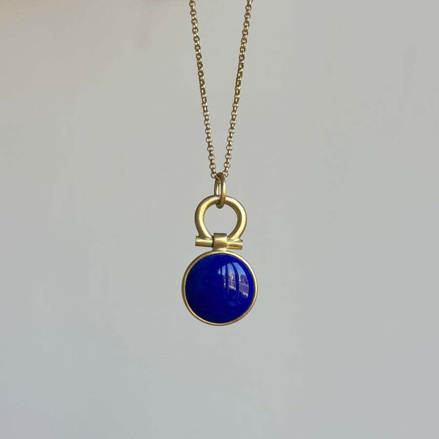Necklace with a blue pendant on a light gray background