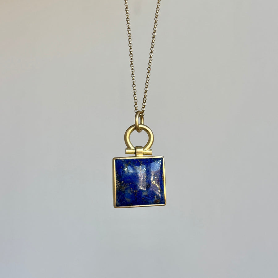Necklace with a square blue pendant on a gray background