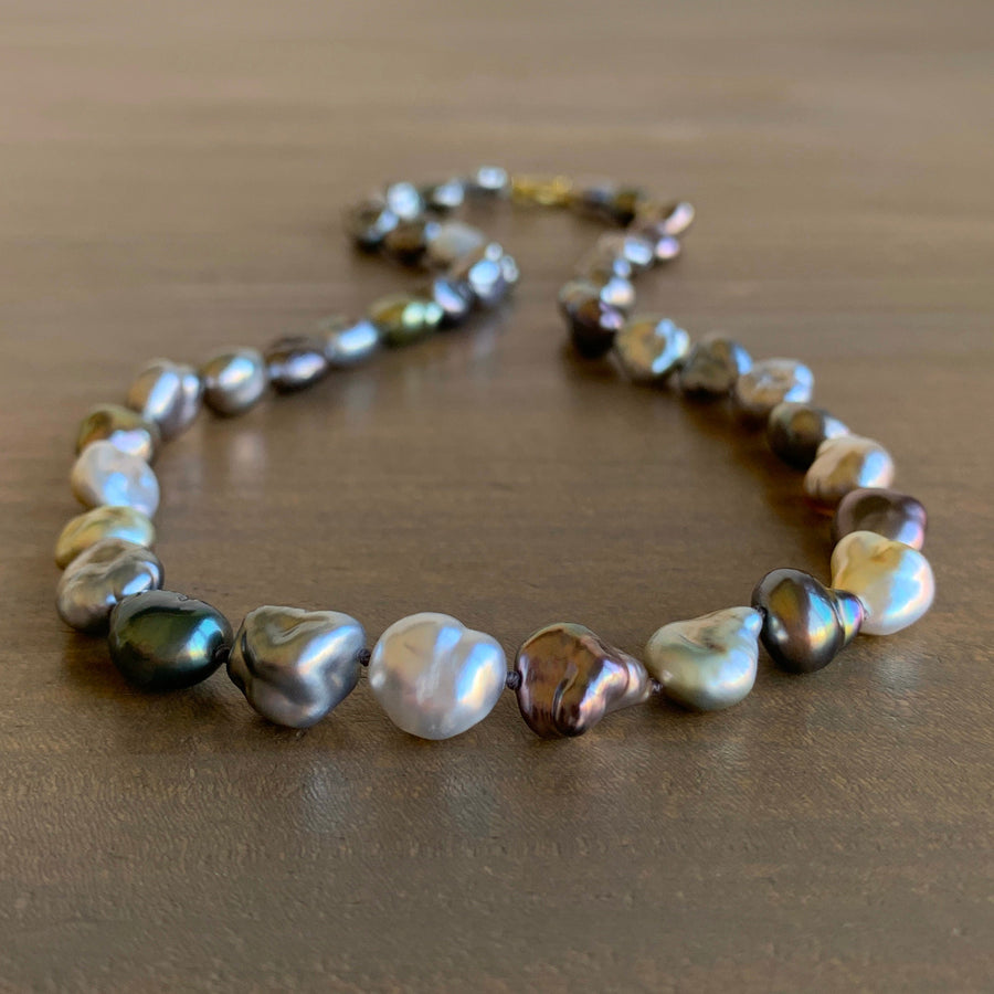 Necklace with multicolored pearls on a wooden surface