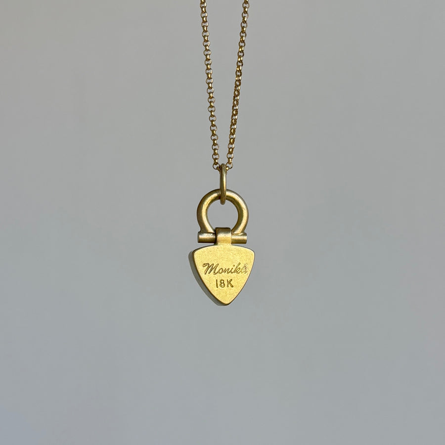 Gold necklace with a heart-shaped padlock pendant on a gray background