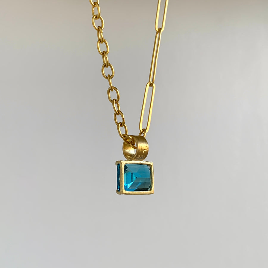 Petite Emerald Cut London Blue Topaz Pendant in 22k & 18k Gold side view hanging