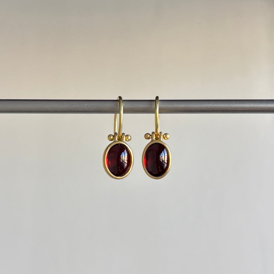 Petite Oval Garnet Cabochon Earrings with Clasps by Monika Krol hanging view