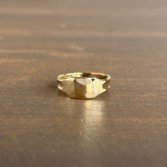 Gold ring on a wooden surface