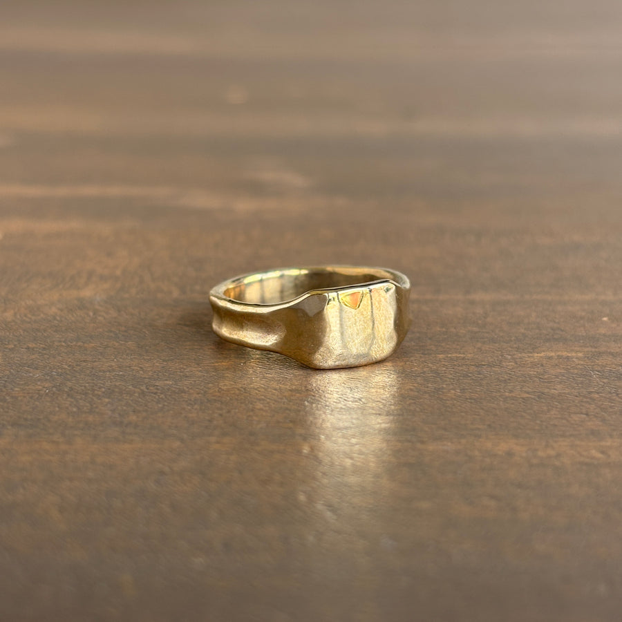 Gold ring on a wooden surface