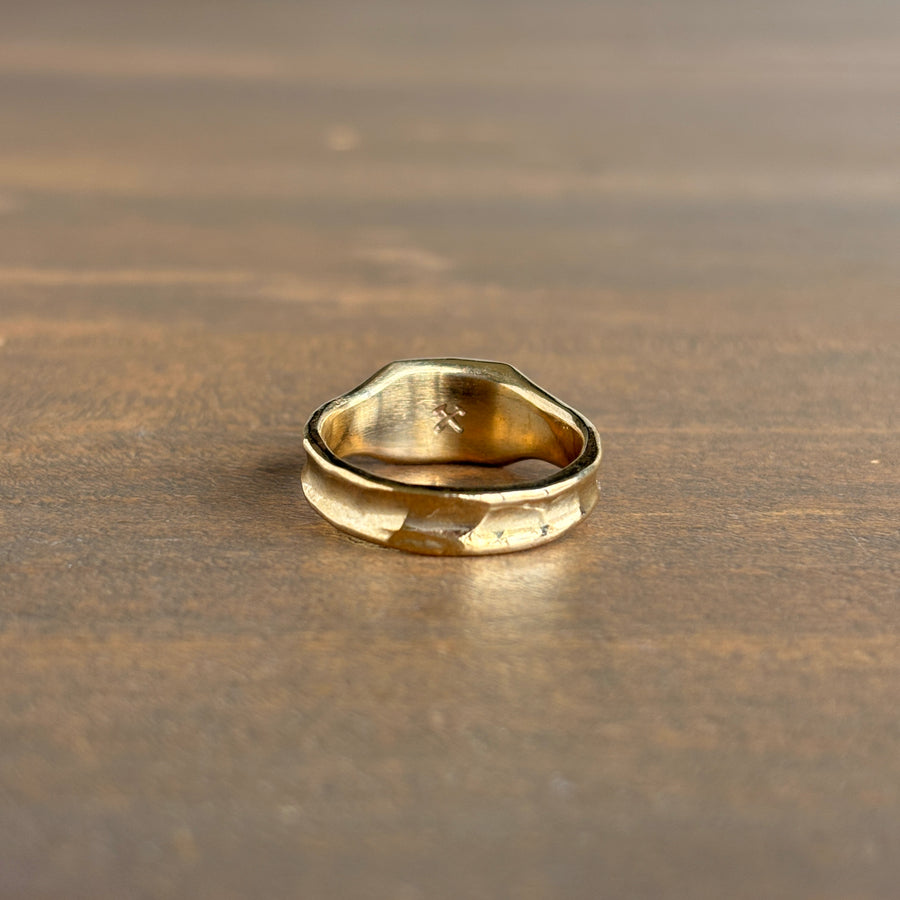 Gold ring on a wooden surface