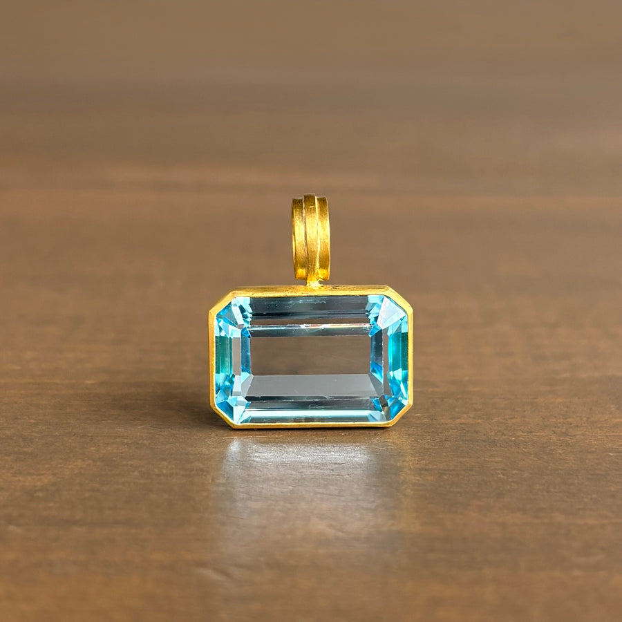 Horizontal Emerald Cut Blue Topaz Pendant in 22k Gold