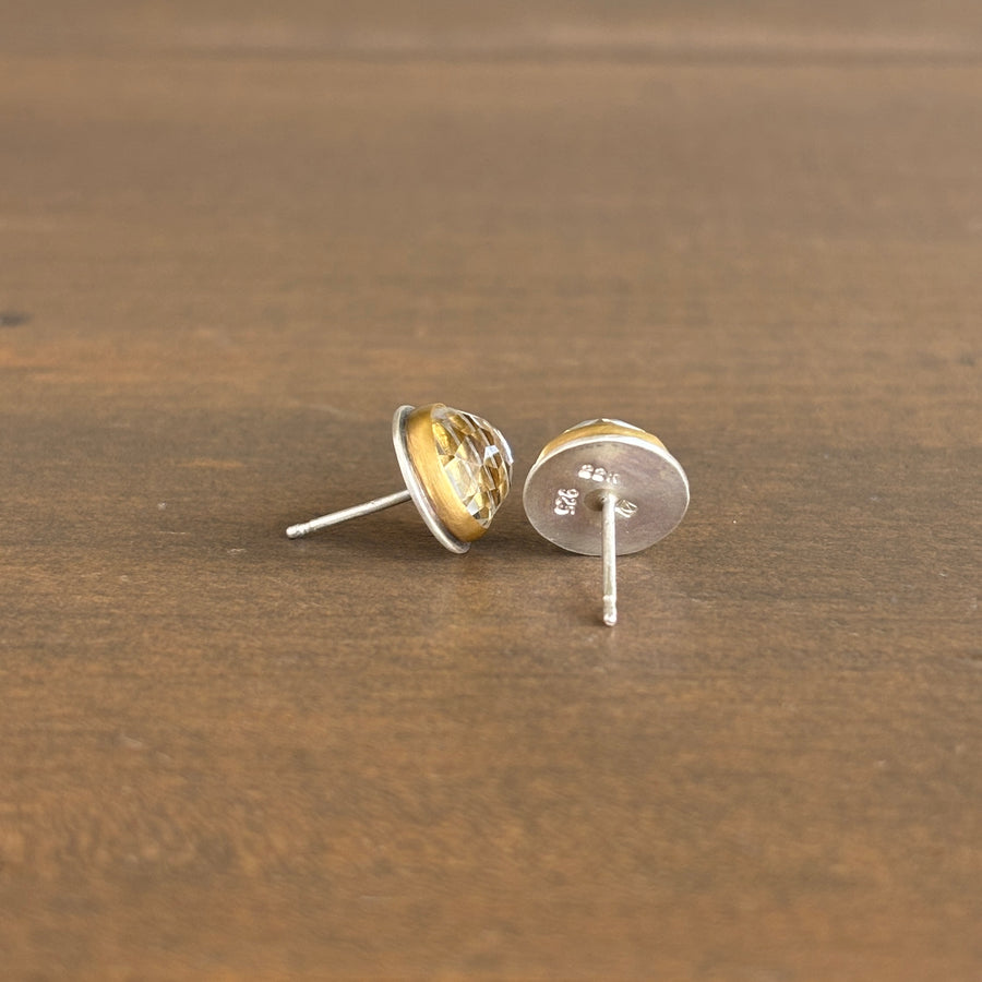 stud earrings on a wooden surface