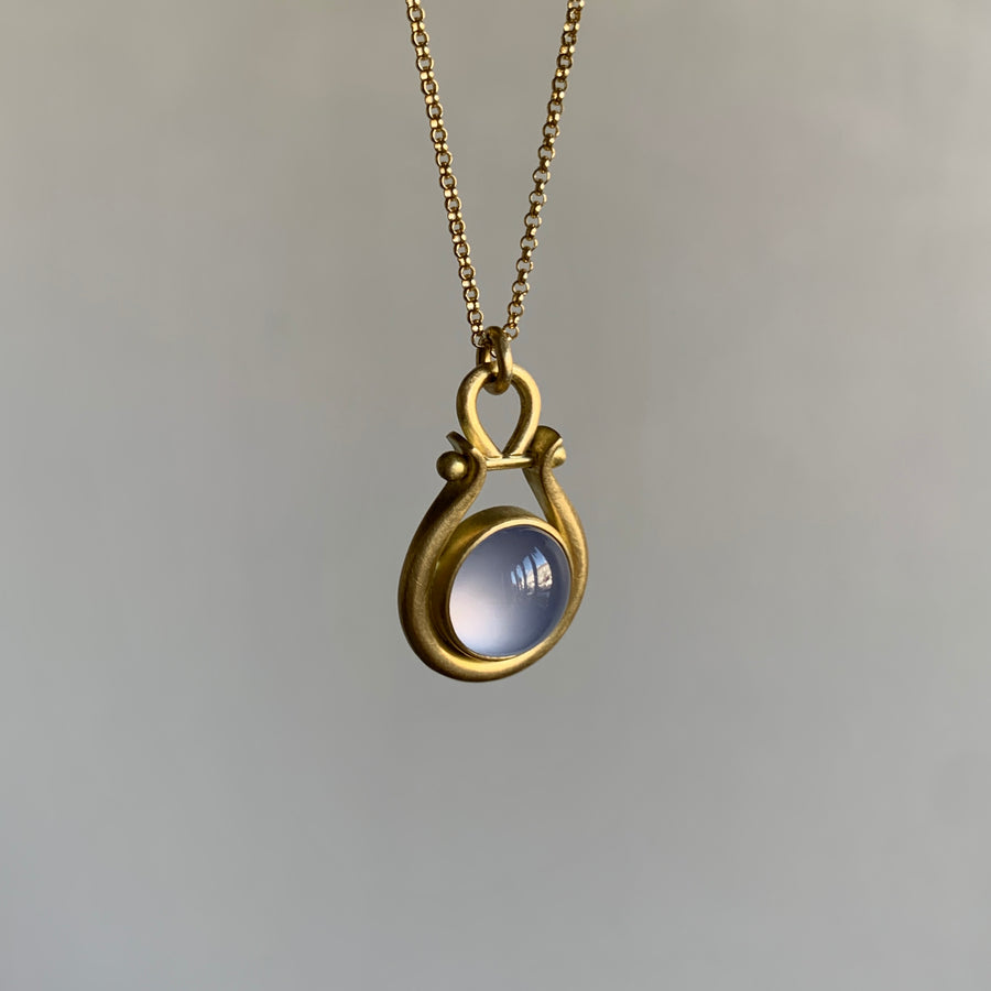 Round Blue Chalcedony Lyre Pendant by Monika Krol hanging view