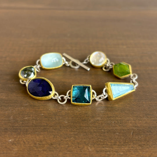Bracelet with colorful gemstones on a wooden surface