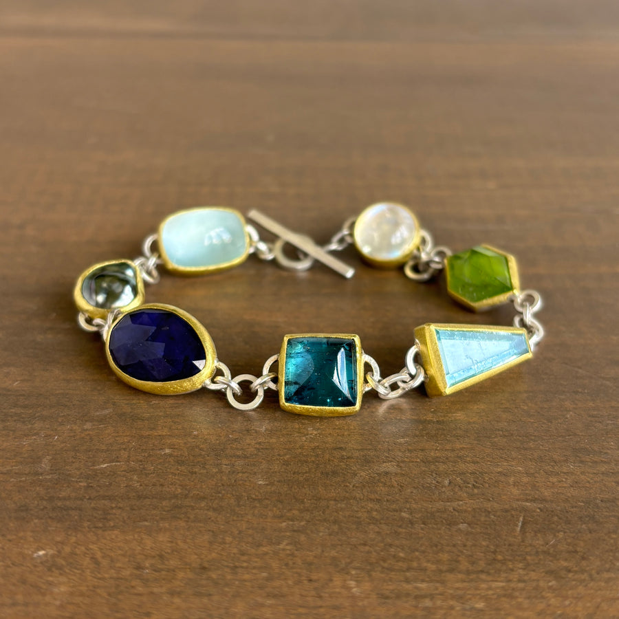 Bracelet with colorful gemstones on a wooden surface