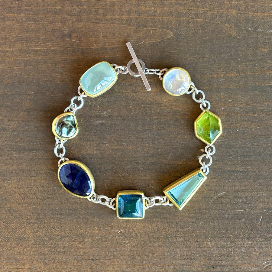 Bracelet with colorful gemstones on a wooden surface