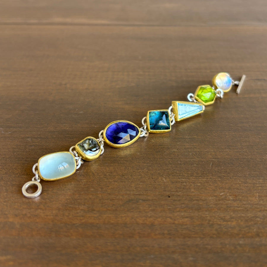 bracelet with multicolored gemstones on a wooden surface