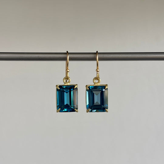 Small 18k Gold & Emerald Cut London Blue Topaz Earrings hanging