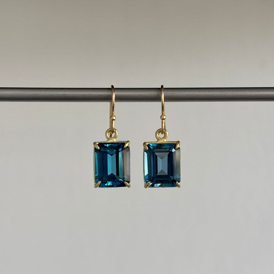 Small 18k Gold & Emerald Cut London Blue Topaz Earrings hanging