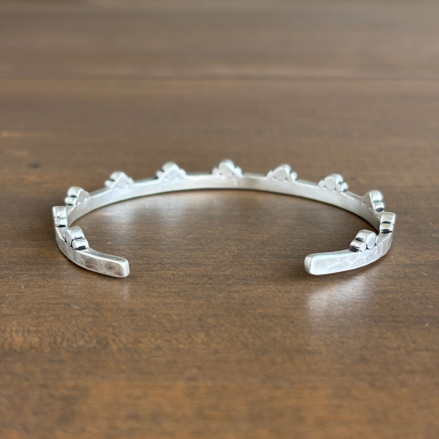 Silver bracelet on a wooden surface