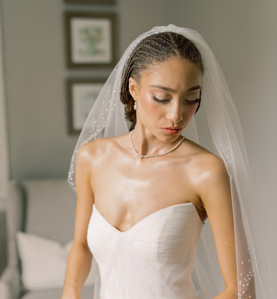 Pearl necklace being worn with wedding dress