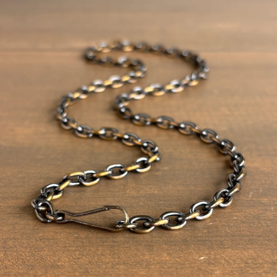 Chain necklace on a wooden surface